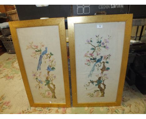 A PAIR OF TALL GILT FRAMED AND GLAZED VINTAGE NEEDLEWORKS DEPICTING BIRDS IN TREES 