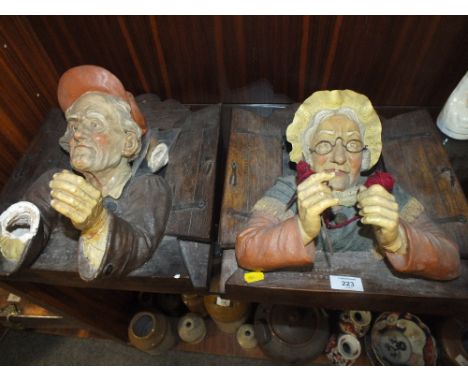 A PAIR OF UNUSUAL CERAMIC FIGURATIVE WALL HANGINGS OF A MAN AND WOMAN ONE A/F 