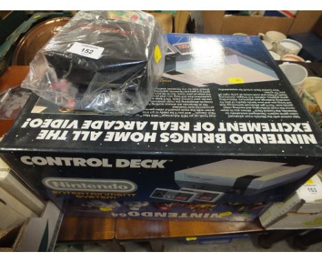 A BOXED NINTENDO NES ADVANTAGE CONSOLE WITH FOUR GAMES TOGETHER WITH A BOXED NINTENDO 64 CONSOLE (2)