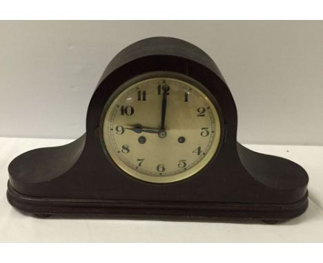 A large wood case mantle clock.