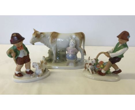3 continental porcelain figures - 2 Hummel style boys and a cow & milkmaid.