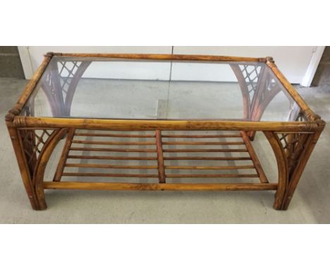 A glass topped bamboo coffee table.