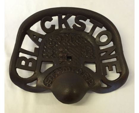 A cast iron reproduction Blackstone tractor seat.