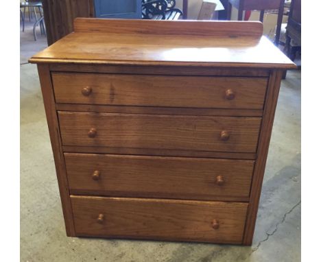 A light oak 4 drawer chest of drawers. 76cm wide & 69cm tall.