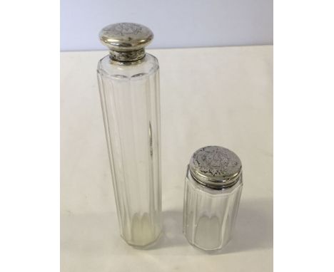 2 silver topped glass bottles.