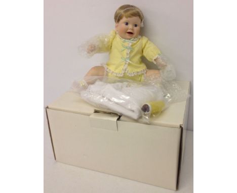 A Danbury mint doll 'Playing Footsie'. In original box with certificate. As new 12 inches tall.