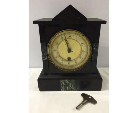 A Victorian black & green marble mantle clock in working order.