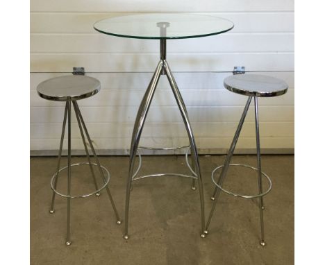 A chrome & glass bistro table with 2 chrome stools.