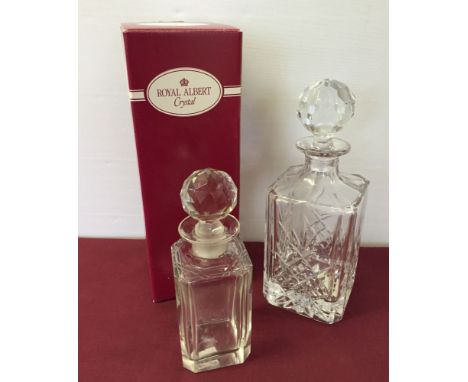 A boxed Royal Albert crystal decanter with another small decanter.
