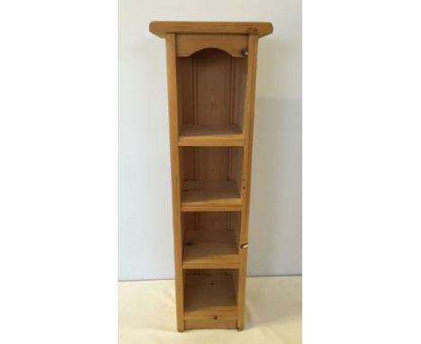 A narrow pine shelf unit 22cm wide x 72cm tall.