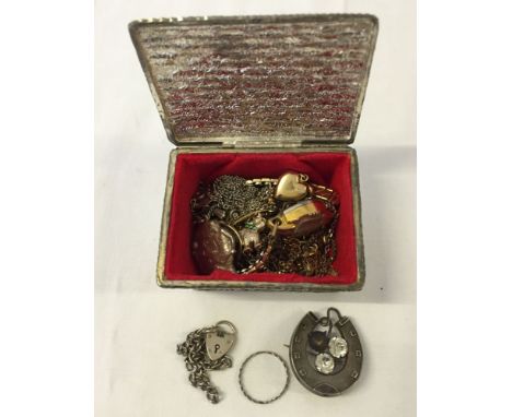 A small white metal trinket box containing jewellery items including a Victorian silver horseshoe brooch and other silver ite