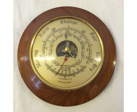 A round wall barometer.