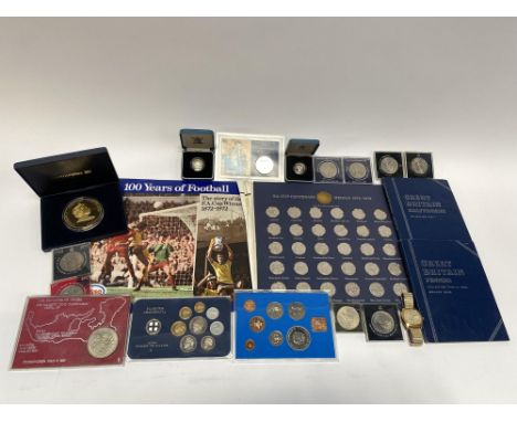 A box of assorted coins and coin sets, to include an FA Cup Centenary 1972 album of coins/medals, commemorative crowns, a Wes