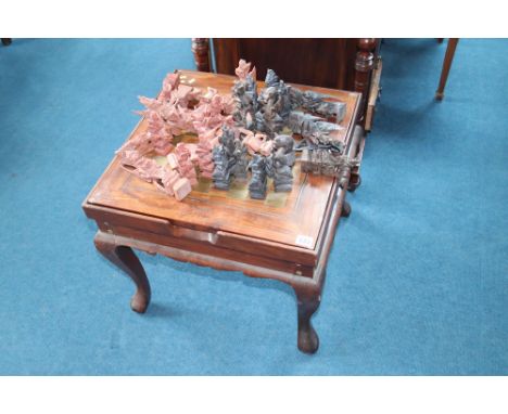 An Oriental carved chess set and table