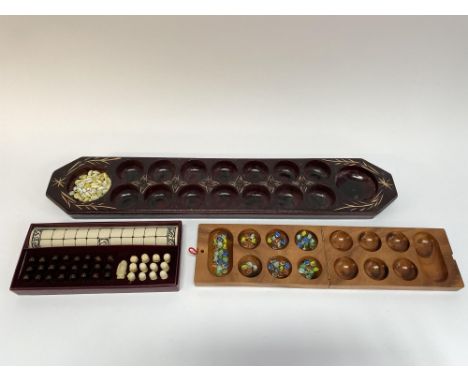 A Mancala game with shells, one other and a Past Times Viking game