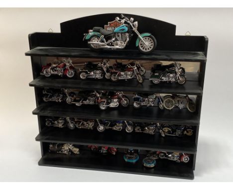 A Harley Davidson mirrored display stand and a selection of Maisto scale models of motorcycles