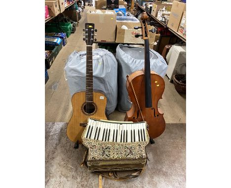 A Hohner accordion, acoustic guitar and cello
