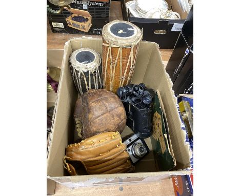 Box containing leather football, catchers mitt, bongo drums, camera and Prinz binoculars