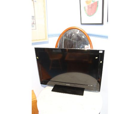 An oval mirror and a Polaroid television