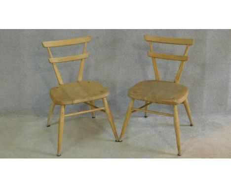 A pair of vintage Ercol child's chairs in blonde beech and elm on turned stretchered supports. H.65cm 
