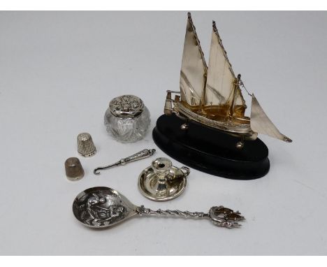 A collection of silver and white metal items. Including a Maltese articulated sailing ship on an ebonised base, a miniature c