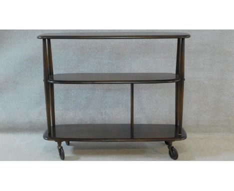 An elm Ercol trolley bookcase, model 361 on industrial style casters. H.76 W.92 D.32cm 
