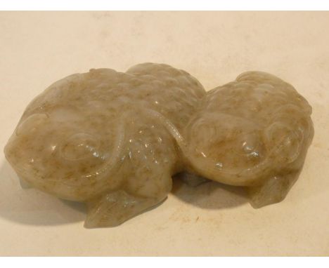 A possibly Qing dynasty Chinese carved celadon jade figure group of two lucky toads with russet detailing. 13x10cm 