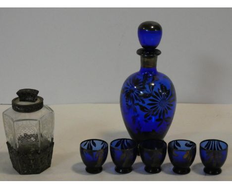 A cobalt blue glass decanter and shot glasses with painted silver floral design along with a German silver embossed repousse 
