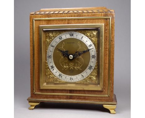 A mid 20th century walnut cased mantel clock by Elliott - the silvered chapter ring set out with Roman numerals on an engrave