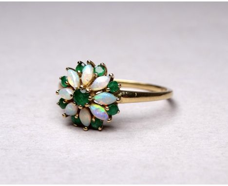 A 9ct yellow gold emerald and opal ring - with a floral setting size Q, 2.3g