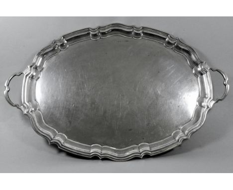 An oval silver tray - Sheffield 1907, Cooper Brothers &amp; Sons Ltd,  with twin handles and moulded scalloped edge, weight 1