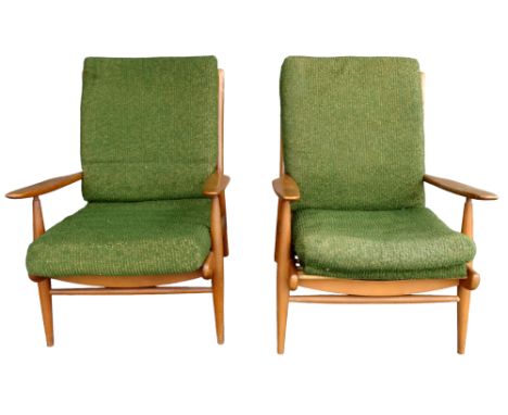 A pair of 20th century Ercol beech framed open armchairs - with green upholstered loose cushions.