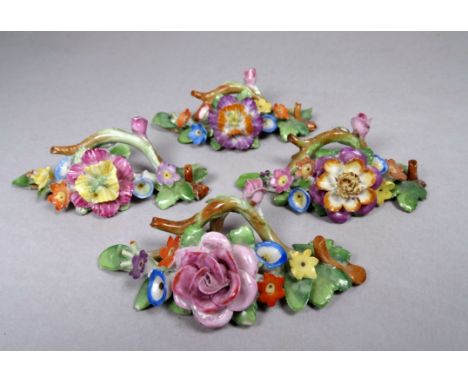 Four early 20th century ceramic place card holders - decorated with foliage and flowers.