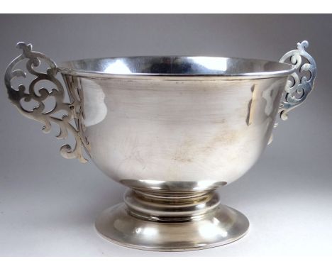 A silver twin handled bowl, Edinburgh 1896, Hamilton &amp; Inches, with pierced handles and raised on a circular foot rim, we