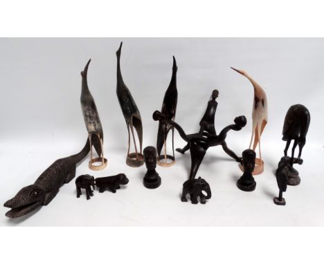 An African hardwood pot stand - of tripod form, carved with figures, together with a hardwood crocodile, two busts, two eleph