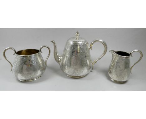 A Victorian silver three piece tea service - London 1875, Richards &amp; Brown, engraved with ribbons and foliage, total weig