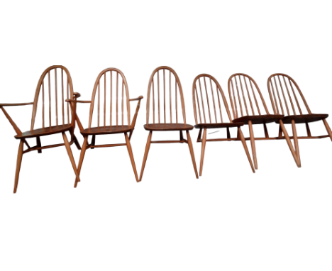 A set of six Ercol dining chairs - including two with arms, the arched stickbacks above solid contoured seats and turned legs