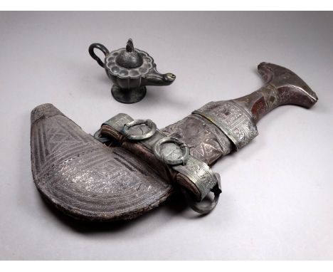 An early 20th century white metal North African jambiya - with typical repousse decoration, length 31cm, together with a pewt