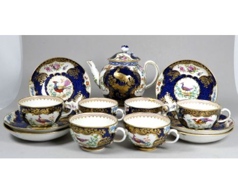 A 19th century part tea service - the bullet shaped teapot with gilt vignettes of exotic birds, height 13cm, together with si