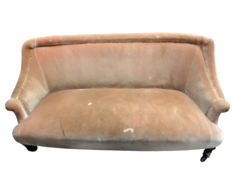 A late Victorian three seat sofa - the low seat upholstered in pink velvet, on short ebonised square tapering legs, width 163