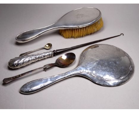 A silver backed hair brush - Birmingham 1912, engraved with initials, together with a hand mirror button hook and spoon