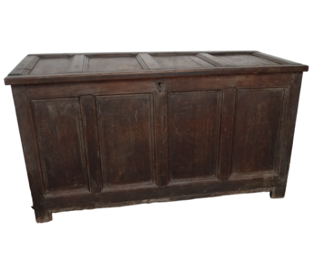A 17th century oak coffer - the four panel hinged cover above a panelled front and raised on stile legs, width 135cm, depth 6