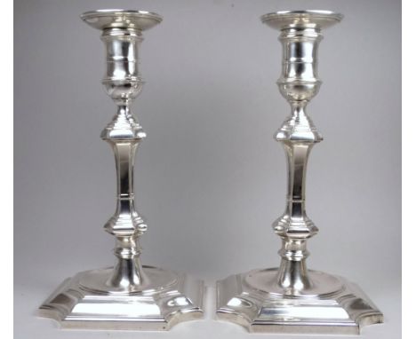 A pair of George III style silver candlesticks - London 1907, Hawksworth, Eyre &amp; Co Ltd, of square baluster form, the wei