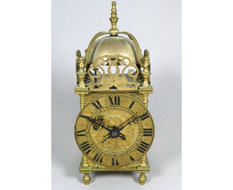 A 17th century style lantern clock - the brass dial set out with Roman numerals, incorporating a bell, fitted with a mid 20th