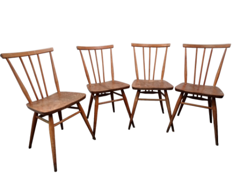 A set of four Ercol dining chairs - the rail back and stick splats joining the peripheral stretcher with solid contoured seat