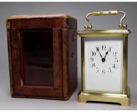 An early 20th century French carriage timepiece - in a brass corniche case, the white enamel dial set out in Arabic numerals 