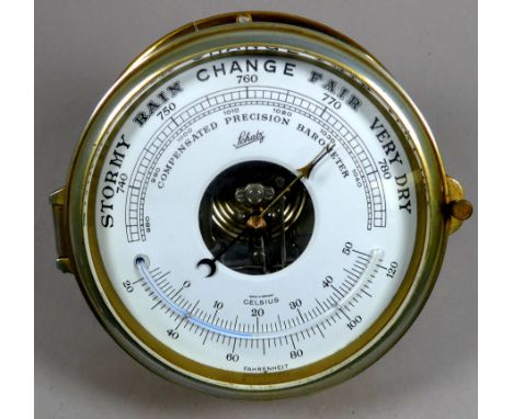 A brass bulkhead aneroid barometer - Schatz, W. Germany, the dial incorporating a thermometer, diameter 16cm. 