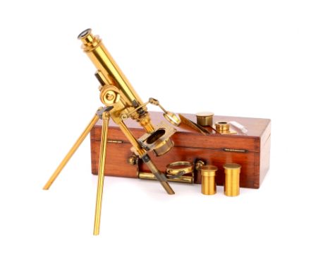English, c.1880, unsigned, constructed of lacquered brass with two fold out legs, plano-concave mirror, simple sliding stage,