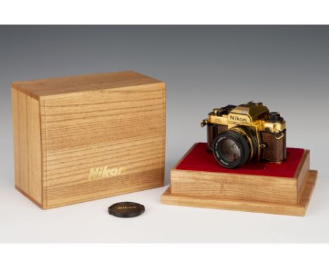 1984, gold, serial no. 2001955, with Nikon Ais Nikkor f/1.4 50mm lens, black/gold, serial no. 5508914, body, G-VG, shutter wo