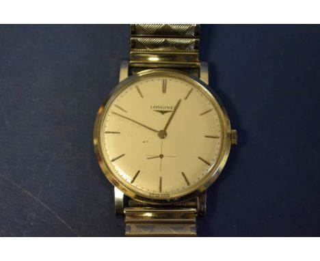 A 1960s Longines stainless steel manual winding wristwatch, on later expanding bracelet. 